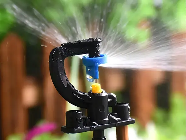 A 180-degree G-type refractive micro sprinkler is spraying water.