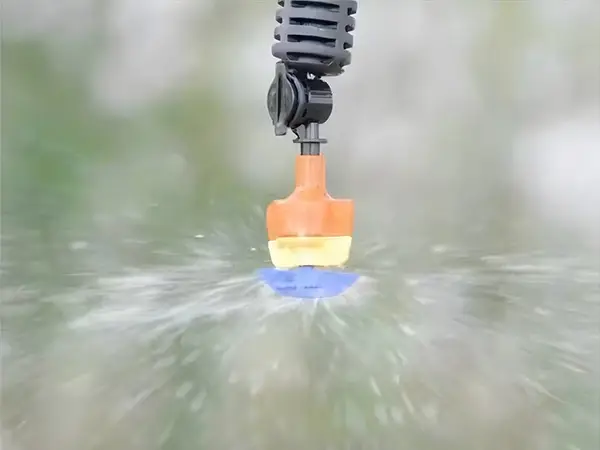 A frameless rotary micro sprinkler is spraying water.