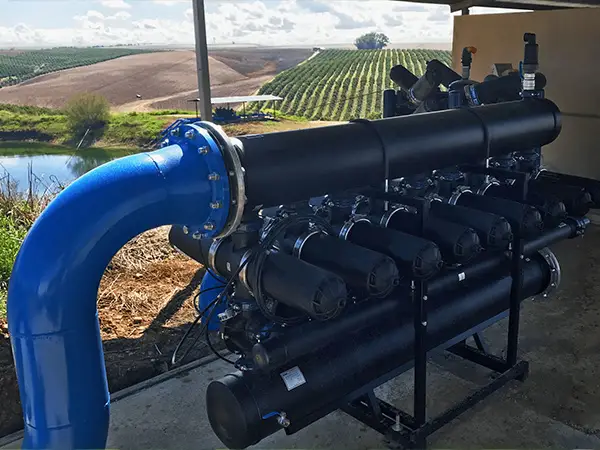 An automatic backwash disc filter is placed on the ground.