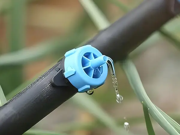 A pressure compensating dripper is dripping water.